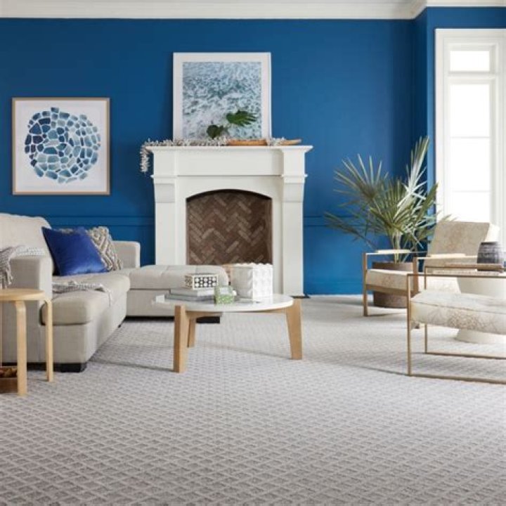 How do you secure a carpet to the wall?